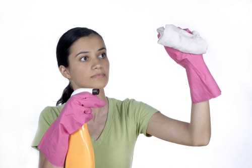 Cleaner working on kitchen surfaces during one off cleaning